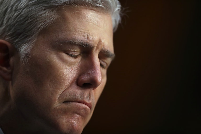 A close-up of a frowning Justice Neil Gorsuch