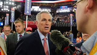 Kevin McCarthy speaks to a reporter on the House floor