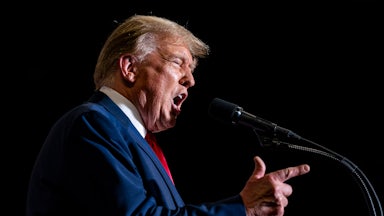 Donald Trump yells at a mic