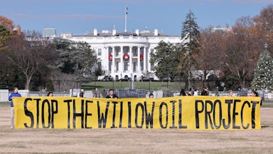Protesters demand President Biden stop the Willow Project by unfurling a banner outside the White House on December 2, 2022.