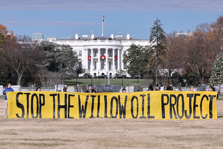 Protesters demand President Biden stop the Willow Project by unfurling a banner outside the White House on December 2, 2022.