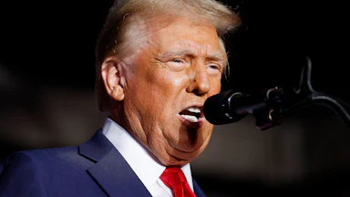 Donald Trump speaking into a mic