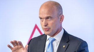 Kevin Roberts raises a hand while speaking