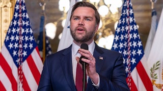 JD Vance gestures while speaking at a podium