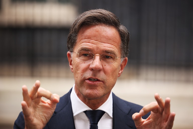 Mark Rutte speaks while making two OK gestures with his hands.