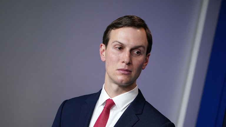 A close-up of Jared Kushner as he casts a glance to the left.