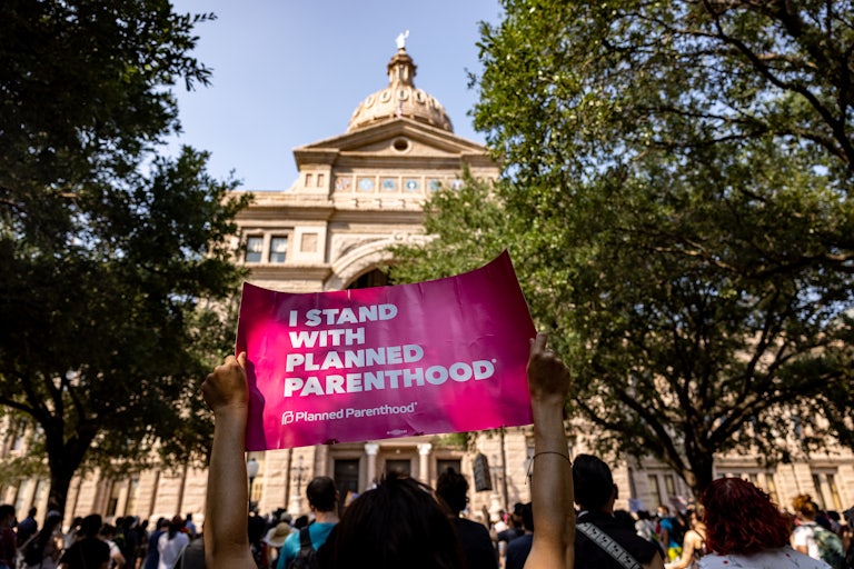 An abortion rights activist holds a sign in support of Planned Parenthood at a rally at the Texas State Capitol 