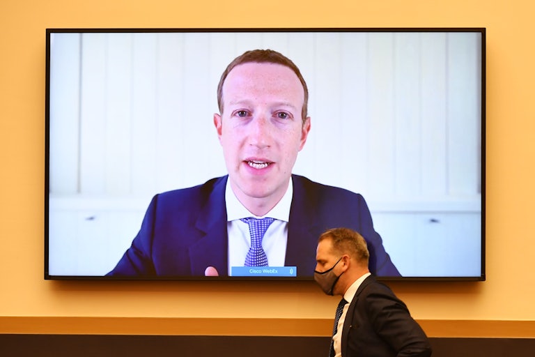 Mark Zuckerberg's face is broadcast on a large flatscreen TV as he testifies before Congress during an anti-trust hearing