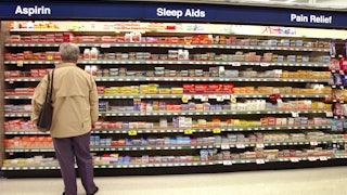 A customer shops for items in a Walgreens store