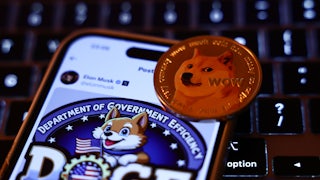 A laptop keyboard, Elon Musk post about DOGE on X displayed on a phone screen and representation of Dogecoin cryptocurrency are seen in this illustration.