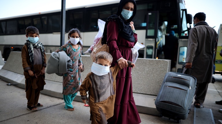 A mother and her three children arrive at Dulles International Airport after being evacuated from Afghanistan.