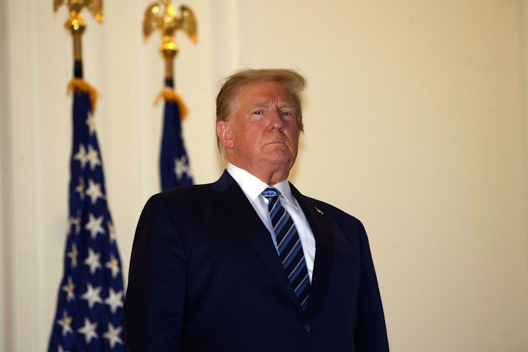 President Trump stands on the Truman Balcony after returning from Walter Reed for medical care.