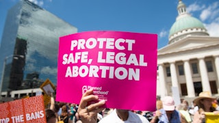 Protesters hold signs as they rally in support of abortion rights in St. Louis, Missouri.