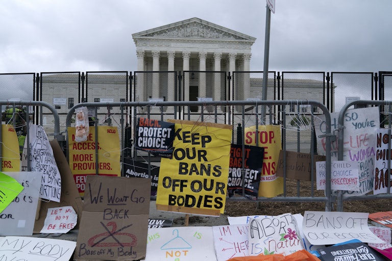 Protest signs line the barricade around the U.S. Supreme Court.