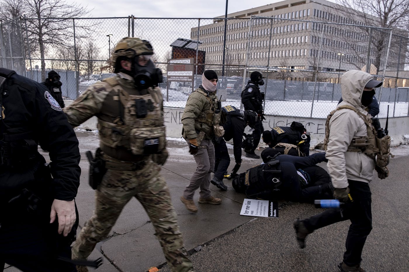 ICE agents tackle a protester