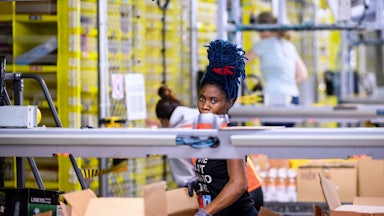 An Amazon warehouse worker loads boxes at a fulfillment center in Staten Island.