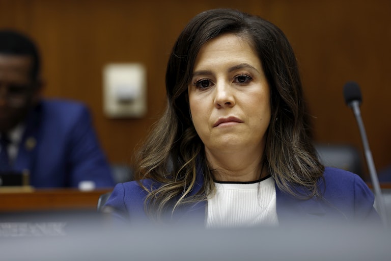 Elise Stefanik sits in front of a microphone