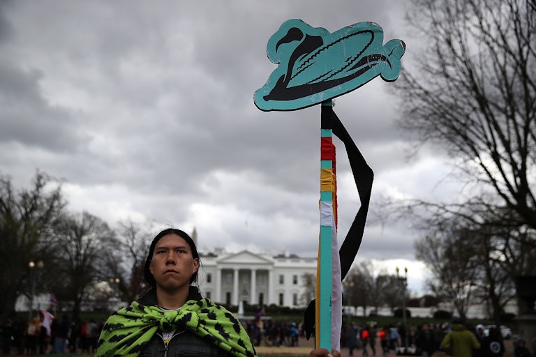 A protester holds a sign during a demonstration against the Dakota Access Pipeline in Washington, D.C., in 2017.