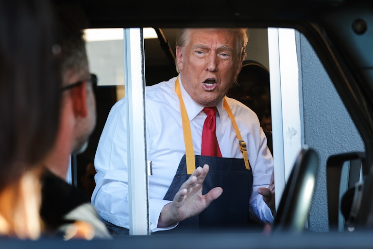 Donald Trump in the McDonald’s window, speaking to someone in the drive-thru