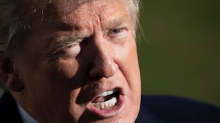 Donald Trump scowls as he speaks to reporters.