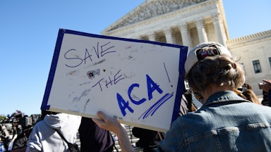 A demonstrator holds a sign in front of the US Supreme Court in support of the Affordable Care Act.