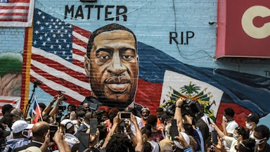 A mural painted by artist Kenny Altidor depicting George Floyd is unveiled in the Brooklyn, New York.