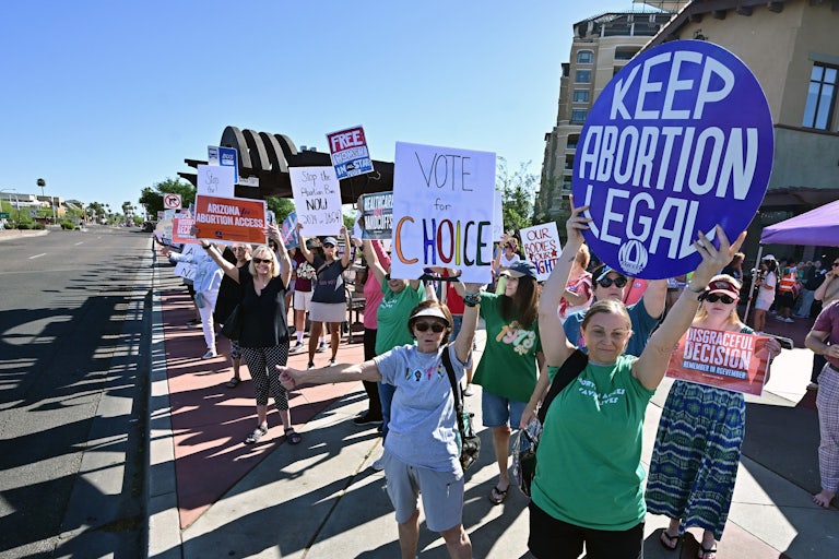 People hold pro-abortion protest signs
