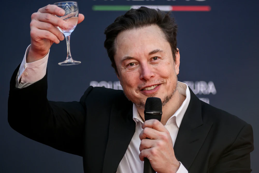 Elon Musk raises a glass as he speaks at a political convention organized by Fratelli d'Italia in Rome, Italy.