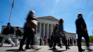 People walk in front of the Supreme Court building.