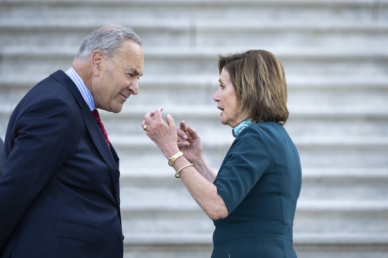 Chuck Schumer and Nancy Pelosi have a discussion on the steps of the Capitol.
