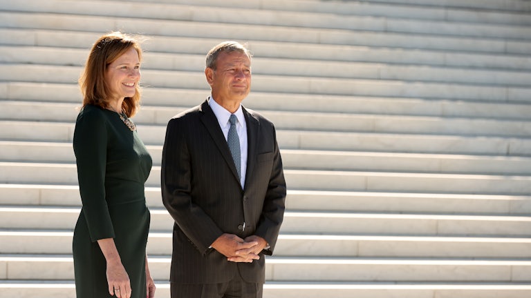 Chief Justice John Roberts and Justice Amy Coney Barrett stand on the steps of the Supreme Court.