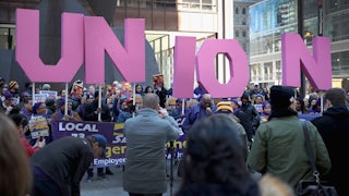 Members of the Service Employees International Union (SEIU) hold a rally in support of the American Federation of State County and Municipal Employees (AFSCME) union