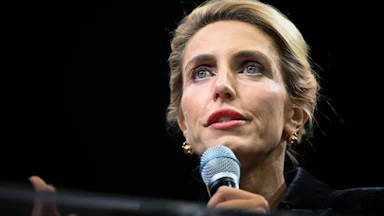 Clarissa Ward holds a microphone up to her face