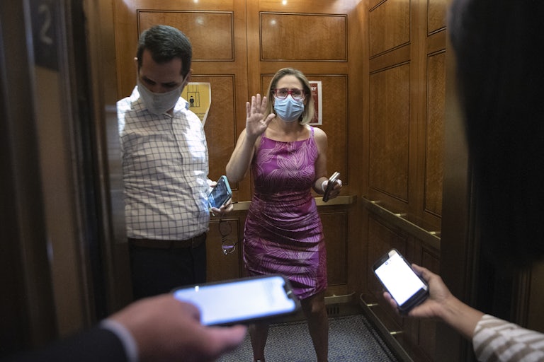 Kyrsten Sinema boards an elevator at the U.S. Capitol