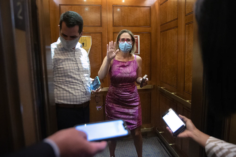 Kyrsten Sinema boards an elevator at the U.S. Capitol