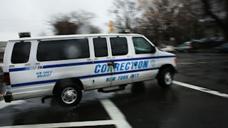 corrections officers van enters Rikers Island