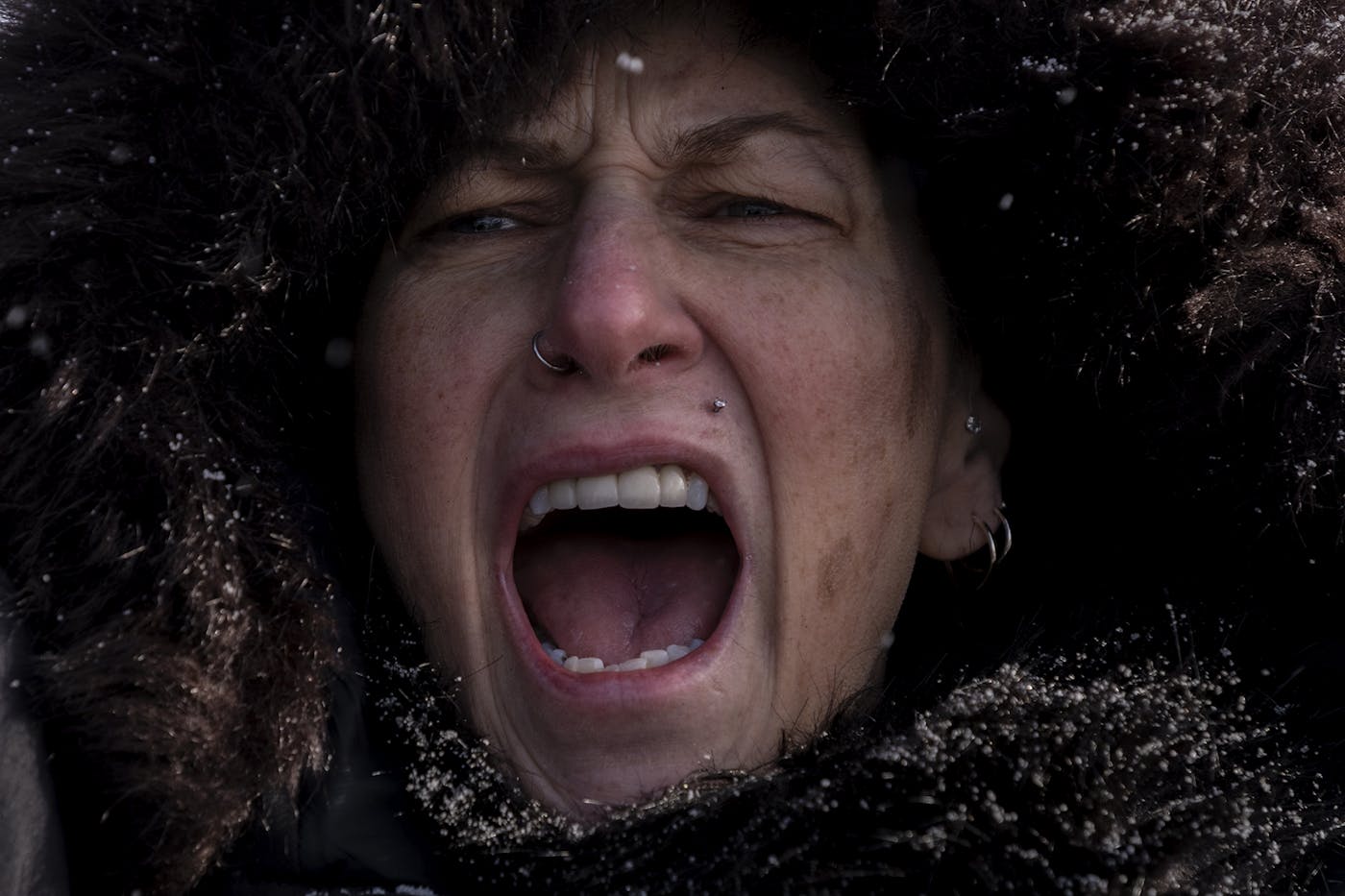 A woman who is an anti ICE protestor screaming at a protest outside of the Bishop Henry Whipple Federal Building
