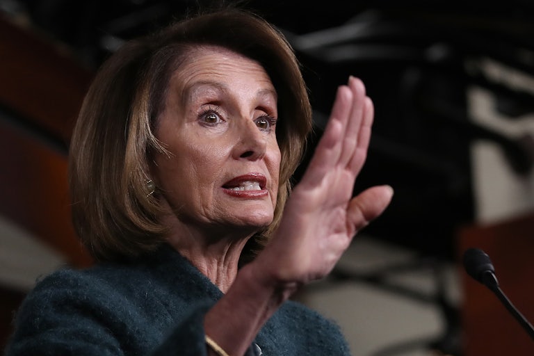 A close up of House Majority Leader Nancy Pelosi, gesturing with her hand.
