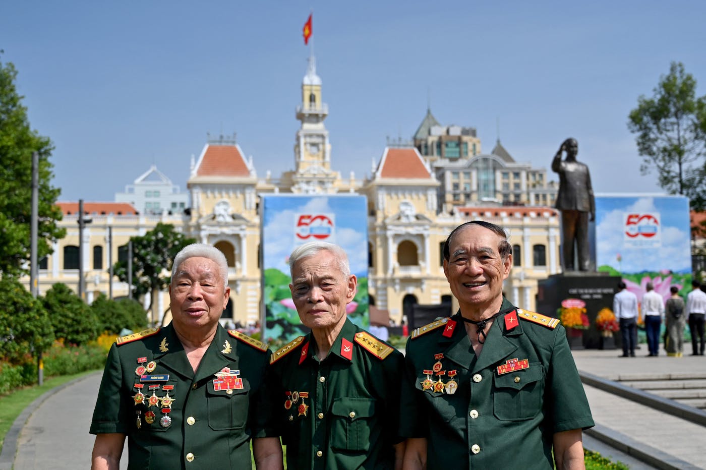 Vietnamese veterans pose in front of the Ho Chi Minh City People's Committee Building in Ho Chi Minh City