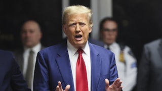 Donald Trump speaks and gestures with his hands