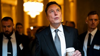 Elon Musk looks up while walking in the U.S. Capitol