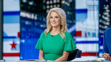 Kellyanne Conway smiles while seated.
