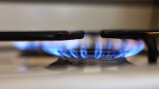 This image shows two lit burners on a gas stove.