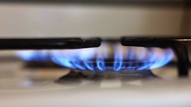 This image shows two lit burners on a gas stove.