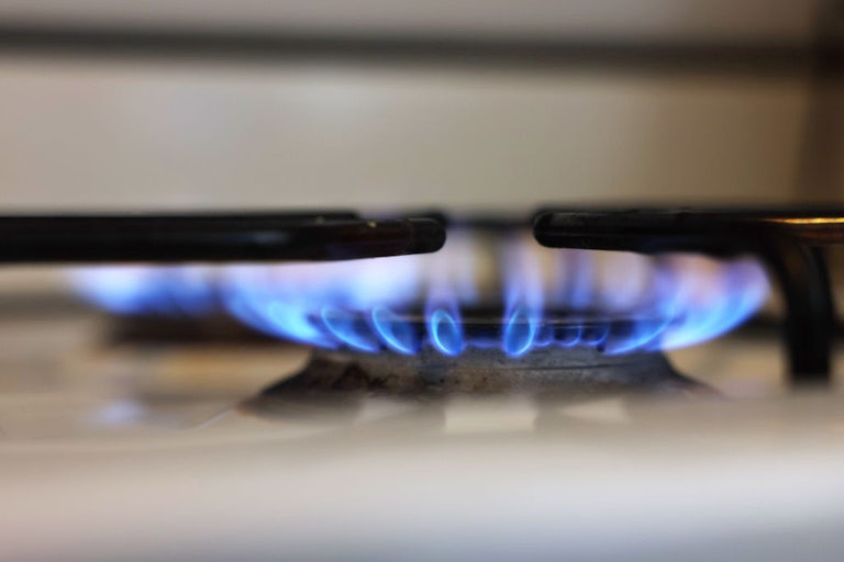 This image shows two lit burners on a gas stove.