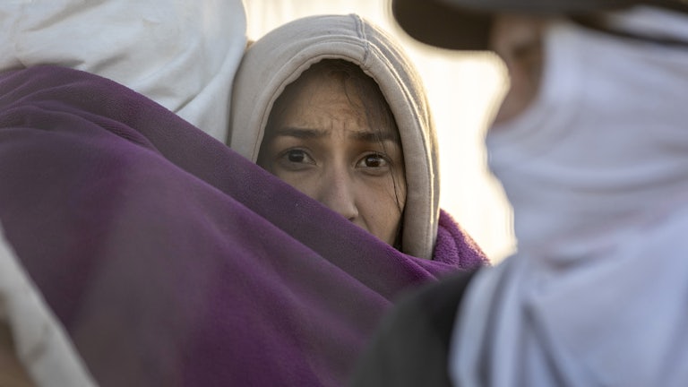 An immigrant looks into the camera.
