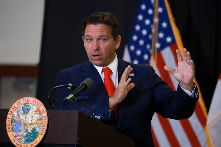Ron DeSantis gestures while speaking at a podium