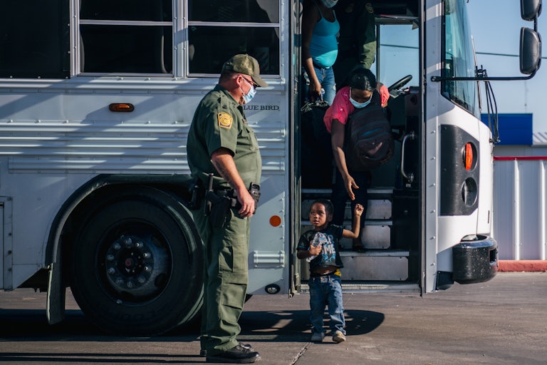 Haitian migrants leave a Border Patrol bus