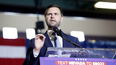 J.D. Vance gestures while speaking at a podium.