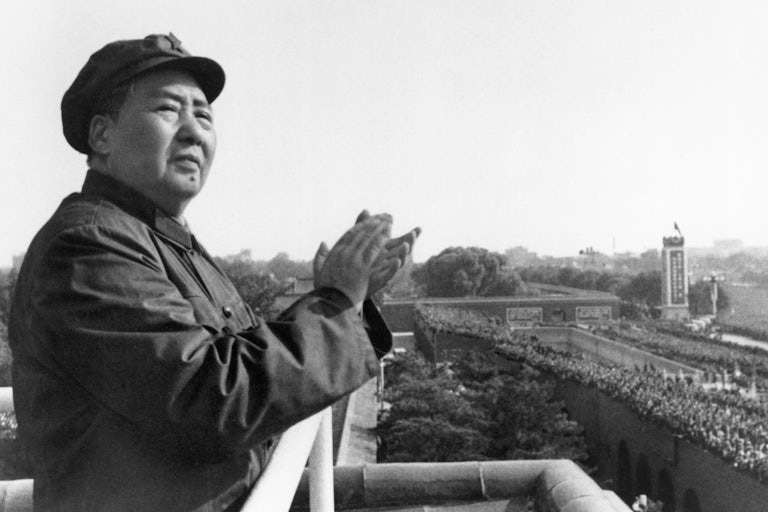 Mao Zedong claps from a balcony